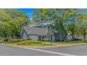 Charming blue home with an attached garage and a well-manicured lawn at 4532 Spyglass Dr., Little River, SC 29566