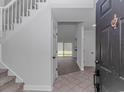 Inviting foyer featuring tile flooring, staircase, and an open layout at 4532 Spyglass Dr., Little River, SC 29566
