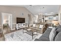 Cozy living room featuring neutral colors, vaulted ceilings, a ceiling fan, and a view of the dining area at 4655 Wild Iris Dr. # 41-303, Myrtle Beach, SC 29577