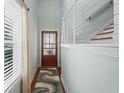 Bright foyer features wood flooring, modern staircase and a wooden door with glass at 5 Ruth St., Murrells Inlet, SC 29576