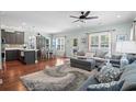 Open-concept living room with hardwood floors, a cozy sofa and a ceiling fan at 5 Ruth St., Murrells Inlet, SC 29576