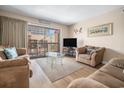 Cozy living room with sliding glass doors to balcony and beach decor at 5505 N Ocean Blvd. # 303, Myrtle Beach, SC 29577