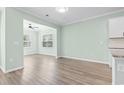 Open-concept dining area with hardwood floors, adjacent to kitchen, and plenty of natural light at 597 Heritage Downs Dr., Conway, SC 29526