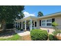 Inviting covered front porch with decorative lattice trim and well-maintained landscaping at 610 Hibiscus Ave. # 610, Myrtle Beach, SC 29572