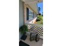 Side view of the covered front porch featuring a brick facade, white lattice detail, and exterior decor at 610 Hibiscus Ave. # 610, Myrtle Beach, SC 29572