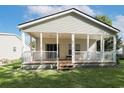 The home has a covered porch, offering a relaxing outdoor space with a backyard and view to neighboring properties at 628 Lake Estates Ct., Conway, SC 29526