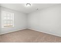 Cozy bedroom with neutral carpet and a bright window at 655 Snowy Owl Way, Conway, SC 29527