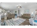 Spacious living room with modern furniture, wood floors, and ample natural light at 668 Rycola Circle, Surfside Beach, SC 29575