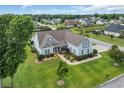 An aerial view of a charming home surrounded by a lush, green lawn and mature trees at 700 Shell Point Ct., Longs, SC 29568