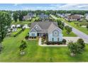 Beautiful neighborhood with pond, lush greenery, and mature trees surrounding an elegant two-story home at 700 Shell Point Ct., Longs, SC 29568