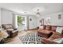 Bright living room featuring hardwood floors, leather seating, and a large window with natural light at 708 15Th Ave., Conway, SC 29526