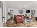 Inviting living room with hardwood floors, a stylish rug, and a comfortable leather sofa at 708 15Th Ave., Conway, SC 29526