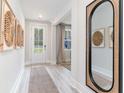 Bright entryway with wood-look floors, white walls, and decorative wall art at 7123 Shooting Star Way, Myrtle Beach, SC 29579
