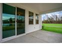 Patio with sliding glass doors, overlooking the green lawn and trees at 7147 Shooting Star Way, Myrtle Beach, SC 29579