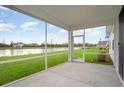 View from the screened-in porch showing a pond, green lawn and trees at 7147 Shooting Star Way, Myrtle Beach, SC 29579