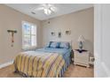 Cozy bedroom with a double bed, neutral walls, and a window with plantation shutters allowing natural light at 876 Palmetto Trail # 103, Myrtle Beach, SC 29577