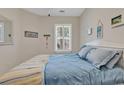 Bedroom featuring a comfortable bed with bright linens and a window dressed with charming plantation shutters at 876 Palmetto Trail # 103, Myrtle Beach, SC 29577