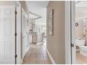 Bright hallway with tiled floor, white doors, and opening leading into the kitchen and living area at 876 Palmetto Trail # 103, Myrtle Beach, SC 29577