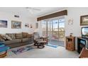 Bright living room with a sofa and recliner near a sliding glass door that fills the space with light at 8861 Chandler Dr. # F, Surfside Beach, SC 29575