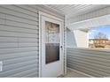 A cozy porch with a welcome sign and a view of the pond beyond, creating an inviting entrance at 8861 Chandler Dr. # F, Surfside Beach, SC 29575