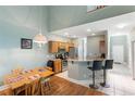 Eat-in kitchen with stainless appliances, breakfast bar and a view to a dining nook with wood floors at 100 Culpepper Way # 1003, Myrtle Beach, SC 29579