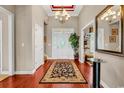 Elegant entryway featuring hardwood floors, stylish rug, transom window, and attractive chandelier at 105 Willow Bay Dr., Murrells Inlet, SC 29576