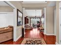 Inviting entryway with hardwood floors, decorative columns, and open view to the spacious living area at 105 Willow Bay Dr., Murrells Inlet, SC 29576