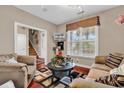 Cozy living room with comfortable seating, large window for natural light, and staircase access at 105 Willow Bay Dr., Murrells Inlet, SC 29576
