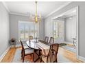Elegant dining room with a wood table, chandelier lighting, and windows with wooden shutters at 116 Sago Palm Dr., Myrtle Beach, SC 29579