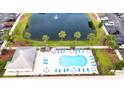 Resort-style pool area with lounge chairs, tables, and umbrellas surrounded by mature landscaping and a nearby parking area at 118 Birch N Coppice Dr. # 6, Surfside Beach, SC 29575