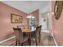 Formal dining room features stylish lighting, wood table and soft, neutral-colored walls at 1206 Formby Ct., Myrtle Beach, SC 29588