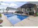 Backyard pool with an outdoor dining area and a nearby hot tub provides the perfect spot for relaxation at 144 Baylee Circle, Aynor, SC 29544