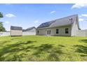 Large backyard with green grass, wood storage shed and solar panels at 1448 Tiger Grand Dr., Conway, SC 29526