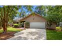 Inviting single-story house boasts a two-car garage and beautiful shade trees at 149 Old Cedar Loop, Pawleys Island, SC 29585