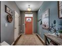 Inviting entryway with wood-look flooring, stylish decor and a warm, peach-colored front door at 153 Goldenrod Circle # 7D, Little River, SC 29566