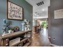 Stylish hallway offers views of the open kitchen featuring pendant lighting and barstool seating at 153 Goldenrod Circle # 7D, Little River, SC 29566