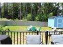 Large fenced backyard with an outdoor dining set and shed; perfect for entertaining and storage at 1600 Beaver Rd., Myrtle Beach, SC 29577