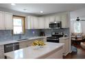 Bright, modern kitchen with white cabinetry, stainless steel appliances, and a stylish backsplash at 1600 Beaver Rd., Myrtle Beach, SC 29577