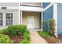 Close-up of entrance showcasing neat landscaping leading to white front door at 1654 Low Country Pl. # C, Myrtle Beach, SC 29577