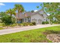 Well-maintained home with a two-car garage, complemented by lush landscaping and a spacious driveway at 1715 Lake Egret Dr., North Myrtle Beach, SC 29582