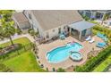 Aerial view showcasing a private backyard oasis with a kidney-shaped pool, spa, and covered patio at 1715 Lake Egret Dr., North Myrtle Beach, SC 29582