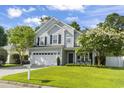Inviting two-story home with a lush lawn, a two-car garage, and a welcoming front porch at 185 Rocko Dr., Myrtle Beach, SC 29579
