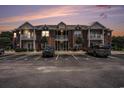 Attractive brick condo building at dusk with manicured landscaping and ample parking at 2005 Silvercrest Dr. # 32F, Myrtle Beach, SC 29579