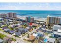 Aerial view showing proximity of coastal home to the beach, ocean, and surrounding neighborhood at 204 55Th Ave. N, North Myrtle Beach, SC 29582