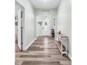 Inviting entryway featuring a decorative sign, arched doorway, and a wood-look flooring at 209 Haley Brooke Dr., Conway, SC 29526