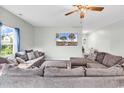 Spacious living room with comfortable sofas, a ceiling fan, and a wall-mounted television at 209 Haley Brooke Dr., Conway, SC 29526
