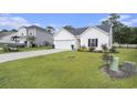 Charming one-story home with a well-maintained lawn, a two-car garage, and tasteful landscaping at 247 Grove Park Grove Park Loop, Murrells Inlet, SC 29576