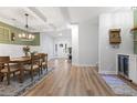 Elegant dining room with wood floors, decorative lighting, and easy access to the kitchen and entryway at 2554 Dogwood Rd., Longs, SC 29568