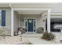 Inviting front porch with seating and a decorative wreath on a stylish blue front door at 2554 Dogwood Rd., Longs, SC 29568