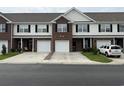 A row of townhomes showcases well-manicured lawns and inviting driveways on a quiet street at 256 Connemara Dr. # 13-C, Myrtle Beach, SC 29579